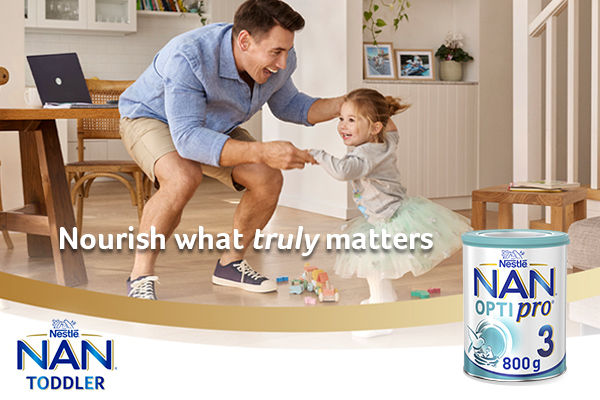 Dad and toddler dancing on the floor; reads: Nourish what truly matters; Nestle NAN toddler.