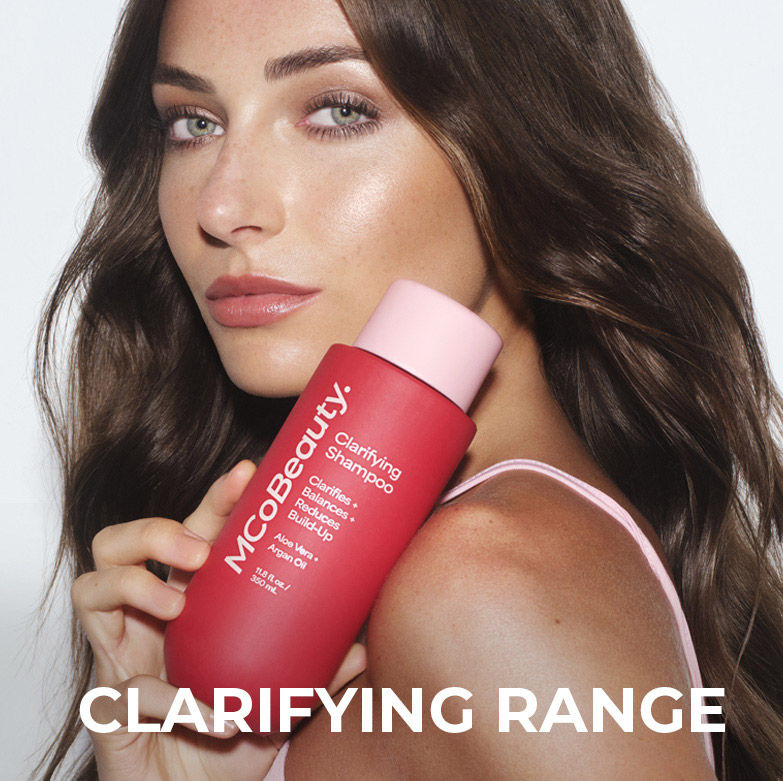 Clarifying range. Women holding bottle of clarifying shampoo. 